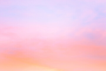 Twilight sky with effect of light in pastel pink, coral, orange, blue tones. Colorful sunset of soft clouds. Background