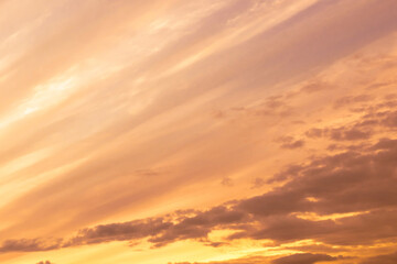 Fototapeta premium Sky with soft and fluffy pastel orange pink and blue colored clouds. Sunset background. Nature. sunrise.