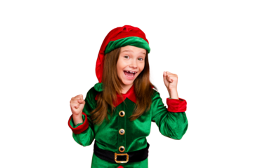 Portrait of shocked elf kid in green hat cap with long red head hairstyle raising her fists celbrate newyear party wearing fairy costume isolated over red background