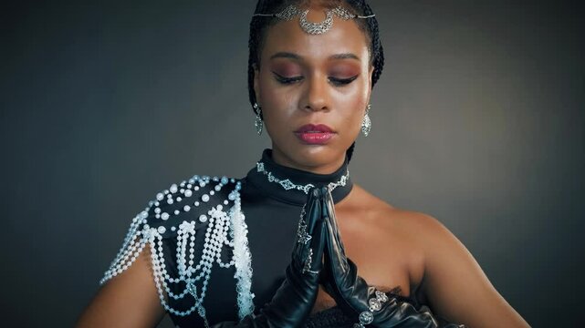 Fantasy portrait african american sexy woman queen priestess of night. tiara diadem crown silver moon head. Creative black dress. Voodoo girl pagan raised hands folded in prayer. halloween costume