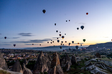 Hot air balloons rise before the sun rises