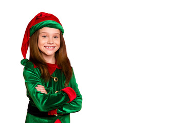 Portrait of cheerful elf kid with her hands crossed smiling ready to help in christmas night...