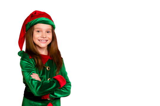 Portrait of cheerful elf kid with her hands crossed smiling ready to help in christmas night wearing green hat fantasy costume isolated over red background - Powered by Adobe