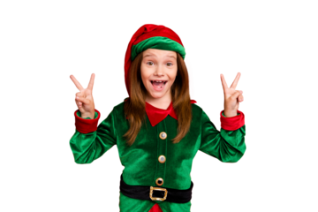 Portrait of crazy elf kid in green hat with long red head hairstyle making v-sign wearing fantasy cap costume isolated over red background