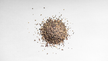 Grounded Black pepper on a white background