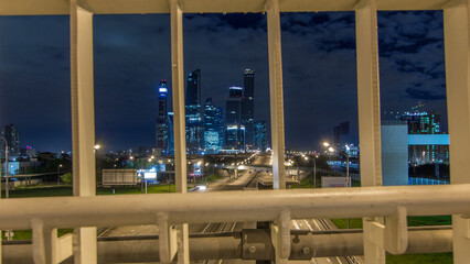 Skyscrapers and transport metropolis timelapse hyperlapse, traffic and lights of cars on multi-lane highways and road junction