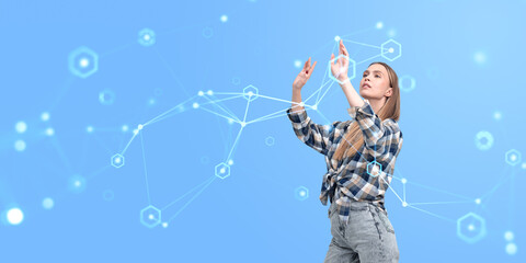 Woman interacting with futuristic digital interface on blue background.