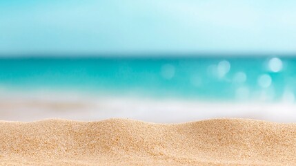Fototapeta premium A beach with a blue ocean and a sandy shore. The sand is a light brown color and the water is a deep blue. The beach is empty and peaceful, with no one in sight