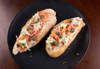 baguette sandwich with smoked salmon and cream cheese and seasonings top view