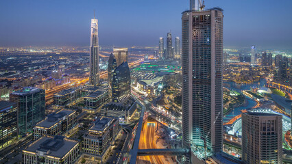 Fototapeta premium Dubai Downtown day to night timelapse modern towers panoramic view from the top in Dubai, United Arab Emirates.