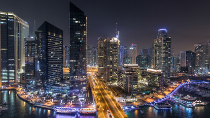 Water canal on Dubai Marina skyline at night timelapse.