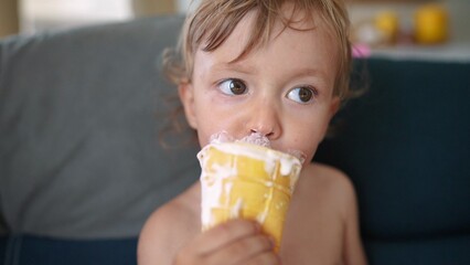 A child is eating ice cream. Icecream chocolate summer concept. A toddler eats ice cream. A toddler eating ice cream with lifestyle a child.