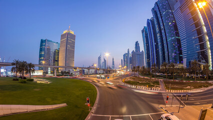 Fototapeta premium Traffic on intersection and bridge at the Sheikh Zayed Road day to night timelapse