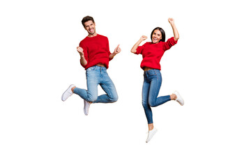 Full length photo of cheerful woman and man jump raise fists scream yes celebrate victory wear red...