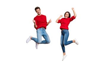 Full length photo of cheerful woman and man jump raise fists scream yes celebrate victory wear red sweater denim jeans isolated over yellow background