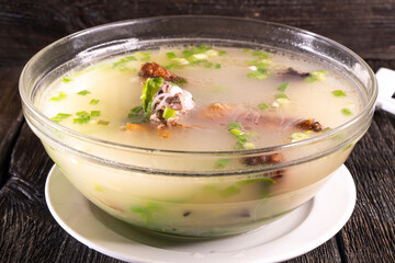 Peking duck soup on wood table.Chinese food. food concept.