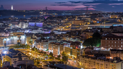 Fototapeta premium Lisbon after sunset aerial panorama view of city centre with red roofs at Autumn day to night timelapse, Portugal