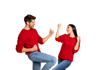 Portrait of delighted two married people raise fists scream yeah celebrate victory wear red sweater denim jeans isolated over yellow background