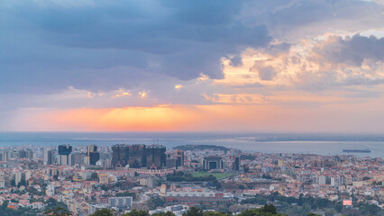 Panoramic sunrise view over Lisbon and Almada from a viewpoint in Monsanto morning timelapse.