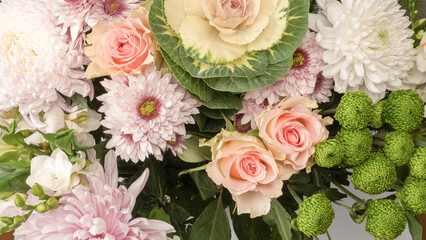 Bouquet of flowers with pink roses, brassica flower, chrysanthemum and freesia flower in a vase.