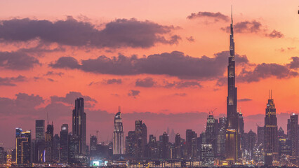 Fototapeta premium View of modern buildings in luxury Dubai city at sunset aerial timelapse