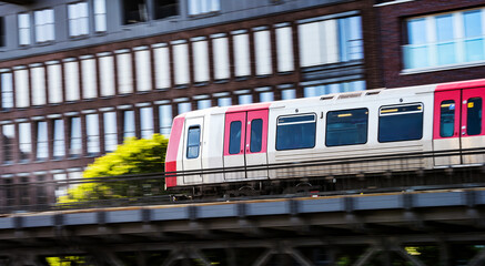Obraz premium Fast Moving Metro Train By Elevated Track In Hamburg