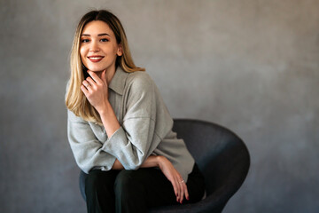 Portrait of a young female designer, business woman in the office. Successful woman freelancer,...