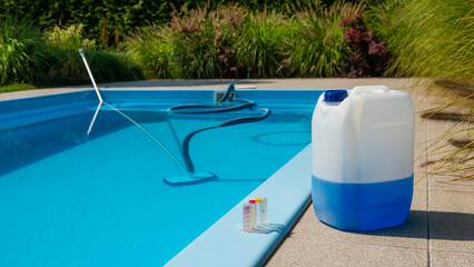 Pool cleaning hose and vacuum head with a large chemical container and water testing kit by the poolside, emphasizing maintenance and water quality.