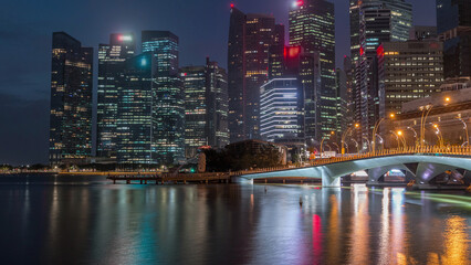 Naklejka premium Esplanade bridge and downtown core skyscrapers in the background Singapore night to day timelapse
