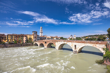 Fototapeta premium The Ponte Pietra roman arch bridge crossing the Adige River in Verona town, Italy, Europe.