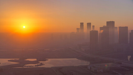 Abu Dhabi city skyline with skyscrapers at sunrise from above timelapse