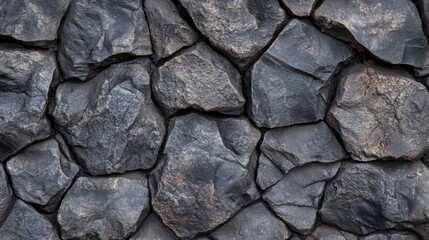 Fototapeta premium Detailed close-up of dark textured rocks, perfect for backgrounds or natural element designs.