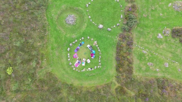 Aerial view of a group of women worshipping at the Beaghmore Stone circles at Blackrock Road by Cookstown in County Tyrone, Northern Ireland
