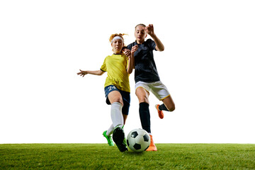 Two determined women, mid-20s, soccer players, captured mid-stride on green field, each pushing their limits in fast-paced, competitive match. Concept of sport, competition, tournament, games, event.