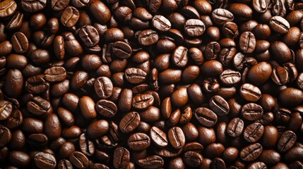 Naklejka premium view from above of a background depicting two dark brown, aromatic coffee beans 