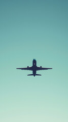 A Silhouette of Hope: A lone airplane ascends against a serene blue sky, promising journeys and new beginnings.