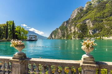 Lake Garda with mountains in background, view from Riva del Garda town shore, Italy, Europe.
