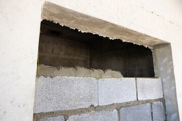 Brick wall background.  Engineering people, construction site. mason worker pouring the ready-mixed...