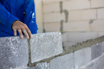 Close up hand construction mason worker bricklayer Engineering people, man construction worker and architecture bricklayers working in work at house construction site. Caucasian men