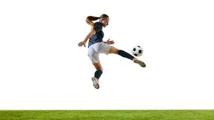 determined female soccer player, mid-20s, airborne, performing impressive acrobatic kick, aiming at ball during competitive match. Concept of sport, competition, tournament, games, event.