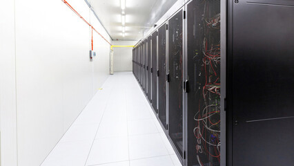 Network servers in a data center. Tier III carrier neutral data center. Server rooms.