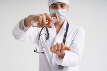 doctor applying antibacterial spray on hand on white background