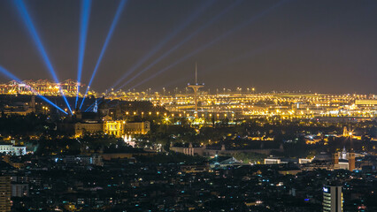 Famous light show and magic fountains timelapse hyperlapse in front of the National Art Museum at Placa Espanya in Barcelona at night, Catalonia, Spain