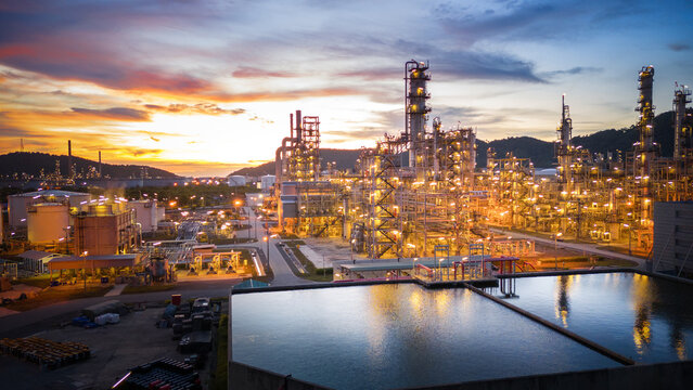 Oil Refinery plant at sunset. Gas Chemical Equipment Prodiction import export Concept, Crude Oil Refinery Plant Steel Pump Pipe line and Chimney and Cooling tower, Chemical Petrochemical