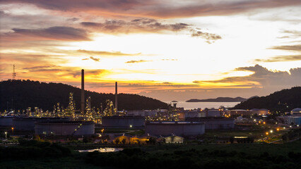 Oil Refinery plant at sunset. Gas Chemical Equipment Prodiction import export Concept, Crude Oil Refinery Plant Steel Pump Pipe line and Chimney and Cooling tower, Chemical Petrochemical