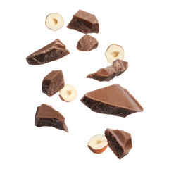 Pieces of tasty chocolate and hazelnuts in air on white background