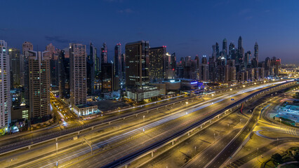 Dubai Marina skyscrapers aerial top view before sunrise from JLT in Dubai night to day timelapse, UAE.