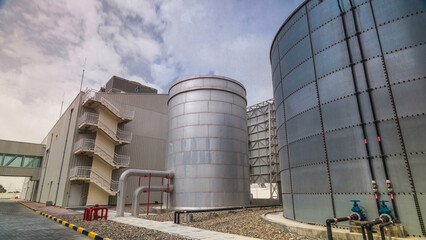Two silver Water Tanks with fence timelapse hyperlapse