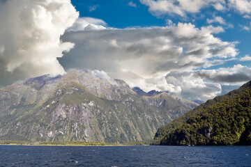 view to the cloudy mountains of the natural wonder milford sound, fjordland national park, southland, new zealand
