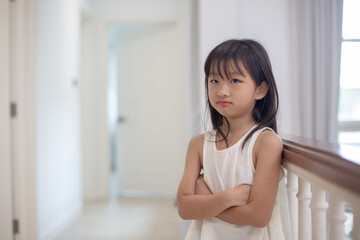 child is depression stress sad to family problems. little girl sits alone crying in her bedroom. Paint from being bitten. Kid girl has pain, is not well, and has a fever.